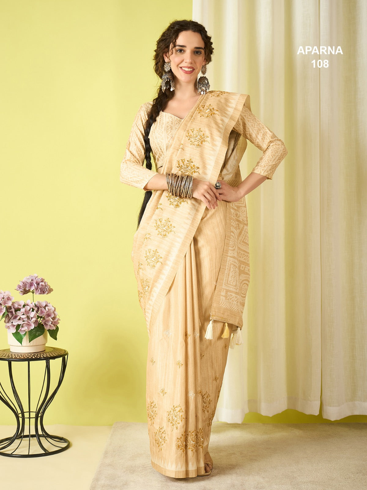 Cream beige cotton blend saree with elegant tribal woven pallu, tassel detailing and soft ethnic printed design by Krishna Textile Market