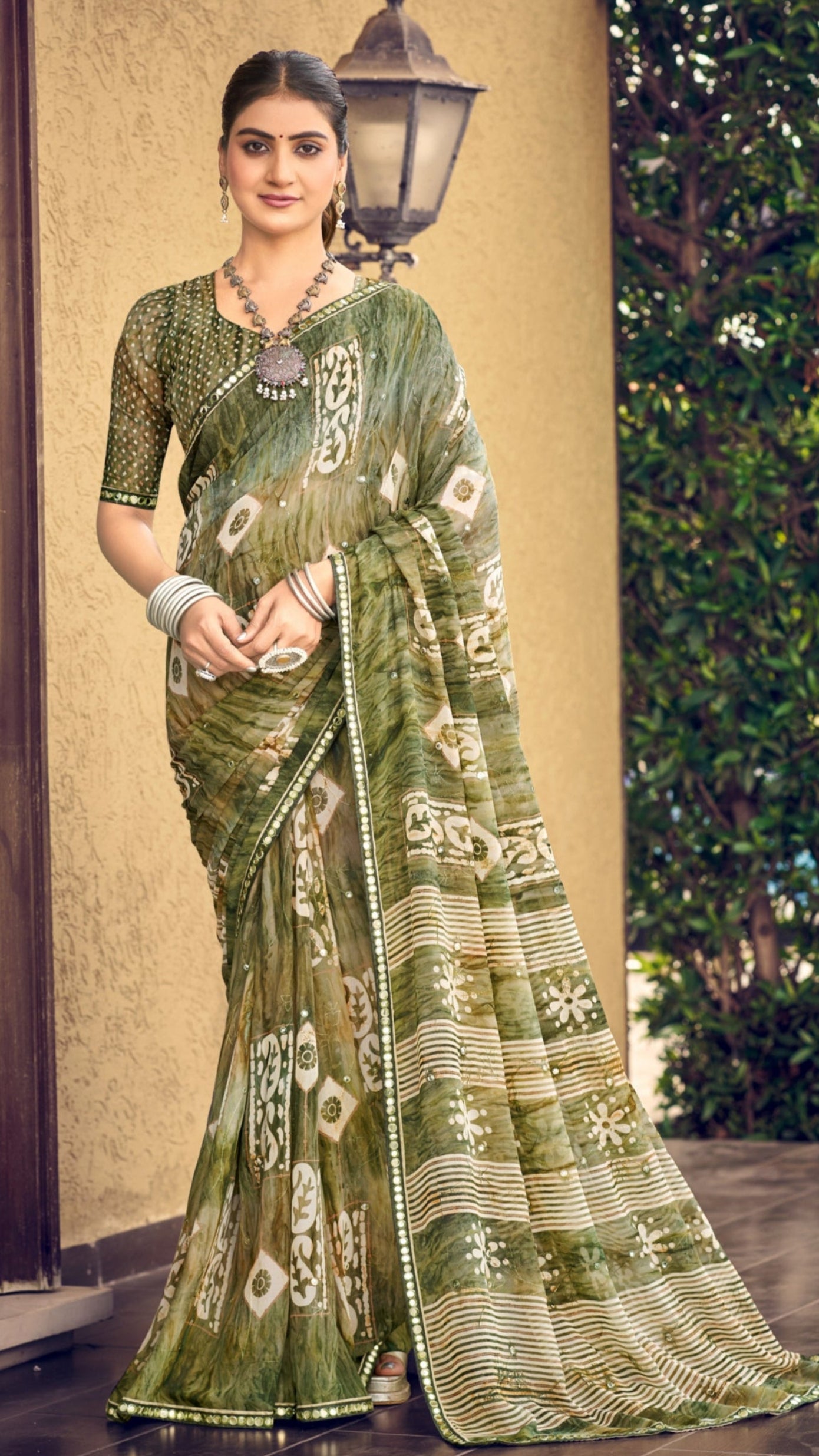 Olive green traditional printed synthetic silk saree with foil mirror work border