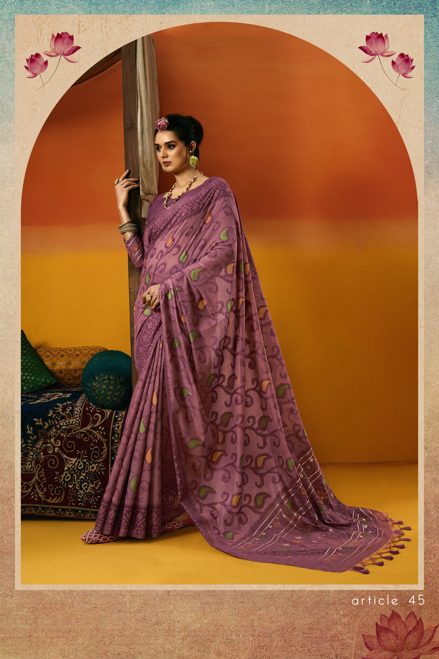 Woman in a purple saree standing against an orange and blue gradient background with floral elements.