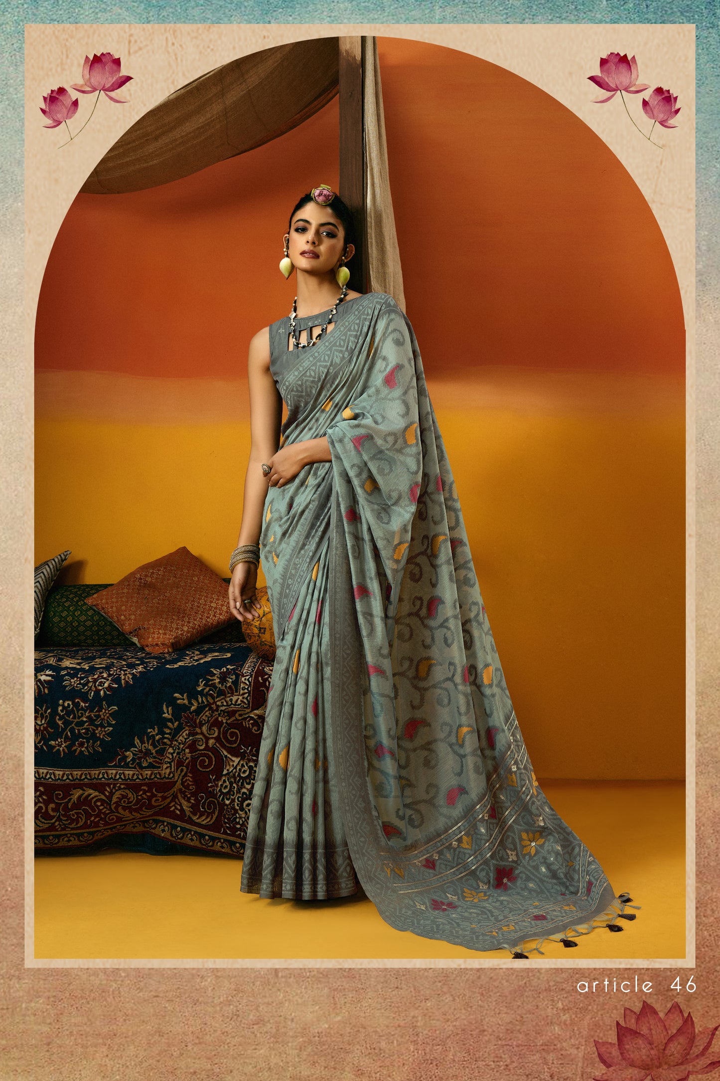 Woman in a traditional saree standing against an arch with a warm color palette