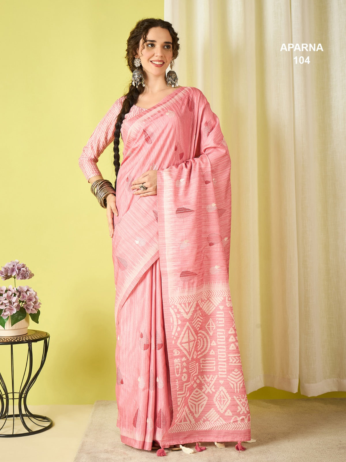 Designer candy pink cotton blend saree with stylish woven pallu, printed ethnic patterns and elegant tassel border detailing