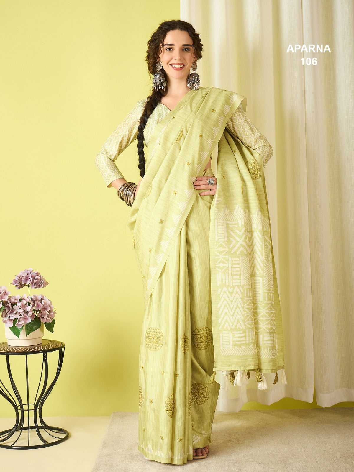 Soft pistachio green cotton blend saree with elegant woven pallu, ethnic print work and tassel finish for casual traditional wear