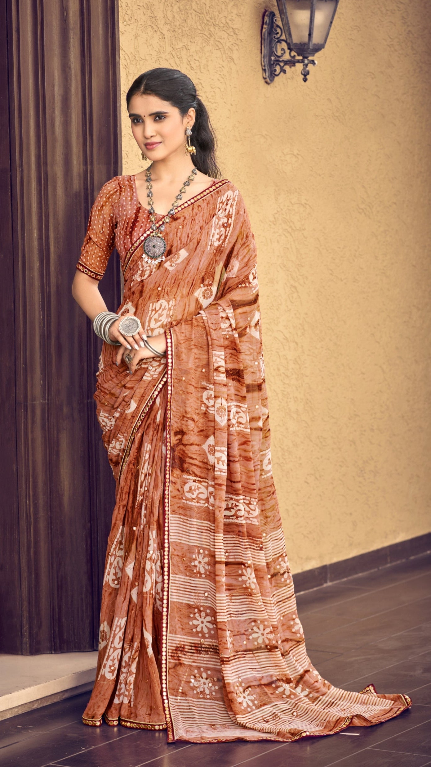 Copper peach traditional printed synthetic silk saree with foil mirror work border