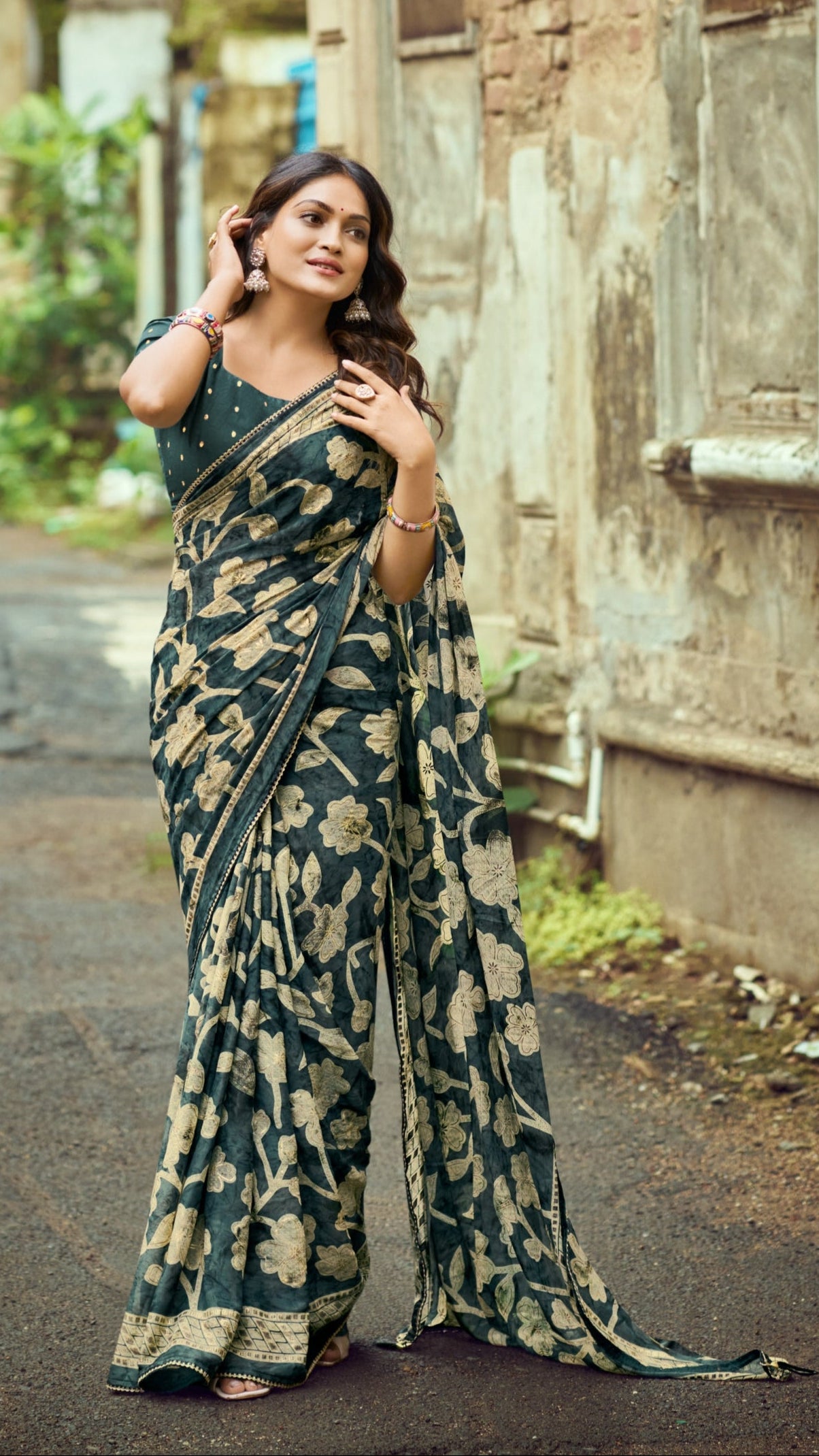 Deep teal green Brasso Silk saree with foil floral print and zari border