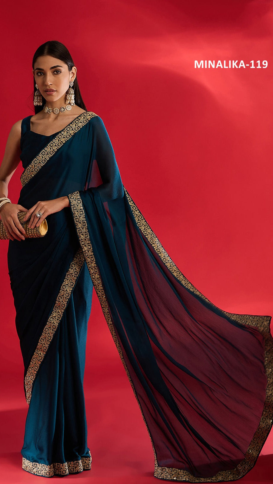 Woman wearing a blue saree with gold border on a red background