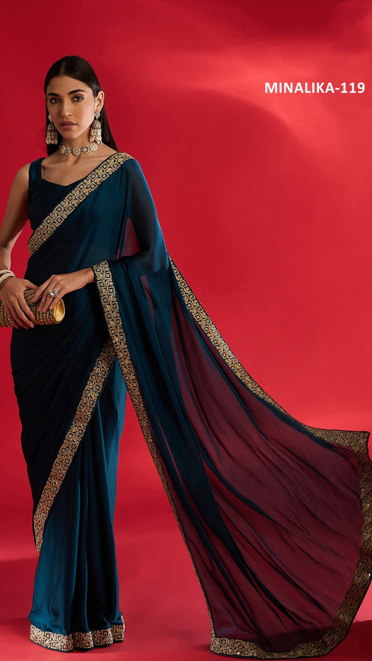 Woman wearing a blue saree with gold border on a red background