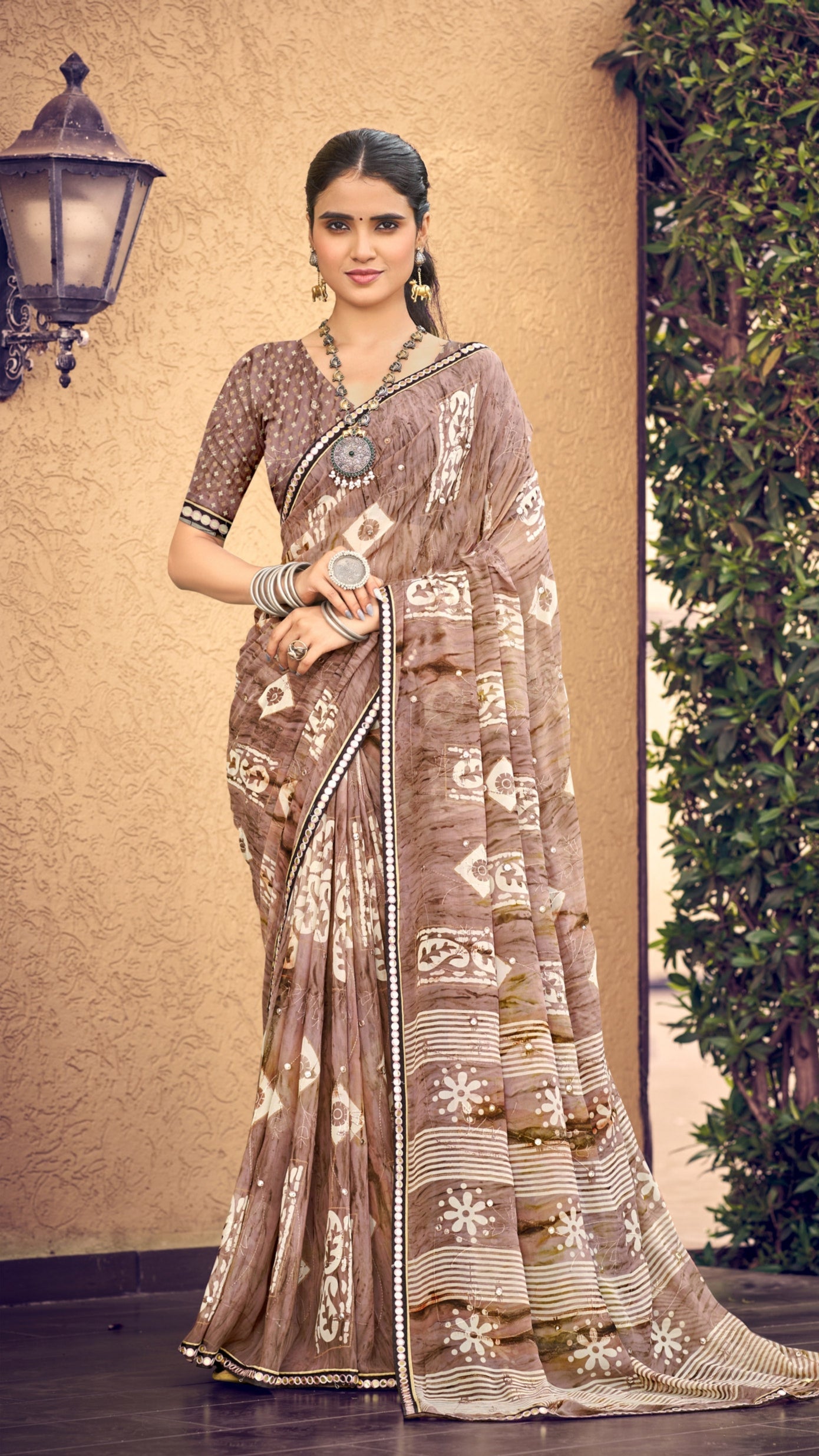 Mocha brown traditional printed synthetic silk saree with foil mirror work border