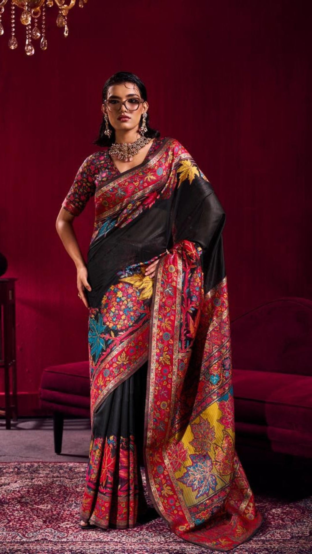 Woman wearing a colorful saree with a red background