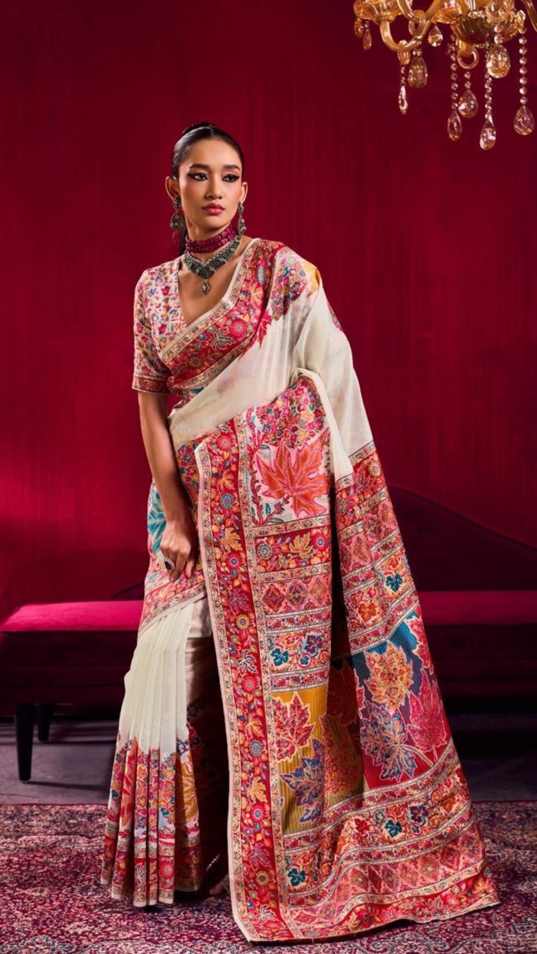 Woman wearing a colorful saree with a red background