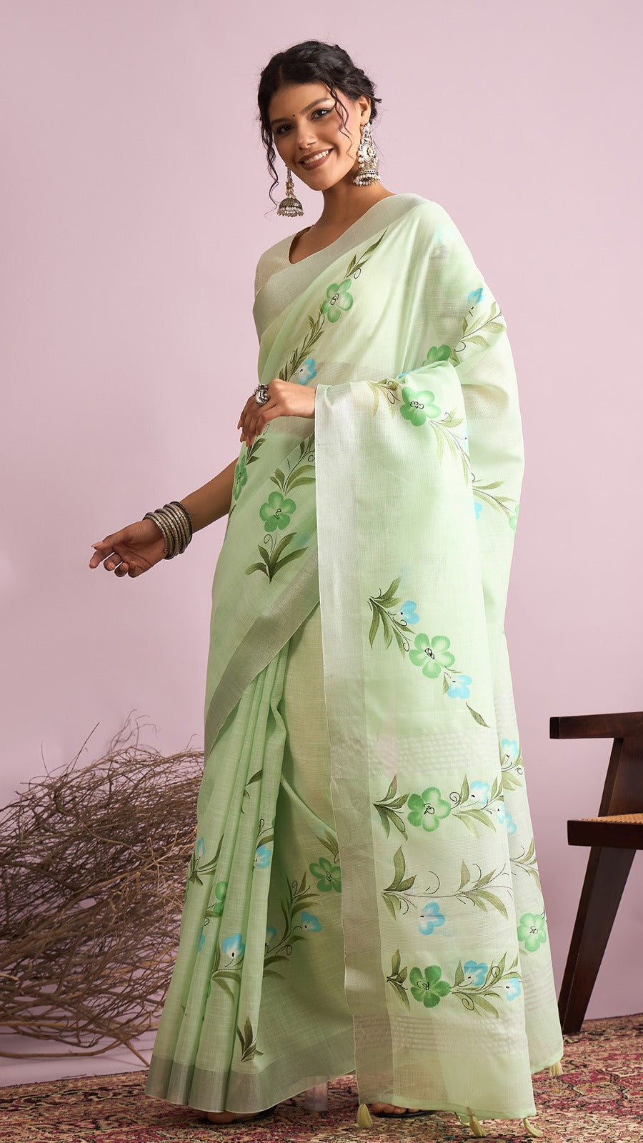 Pastel green linen cotton saree with floral print and elegant casual wear styling