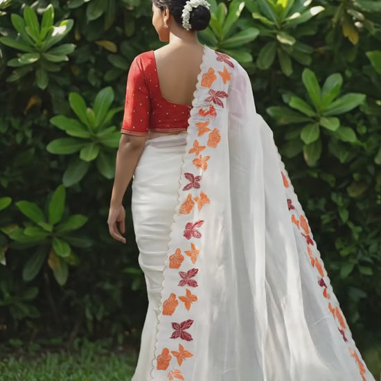 Elegant white chiffon saree featuring butterfly pattern and embroidered cutwork border