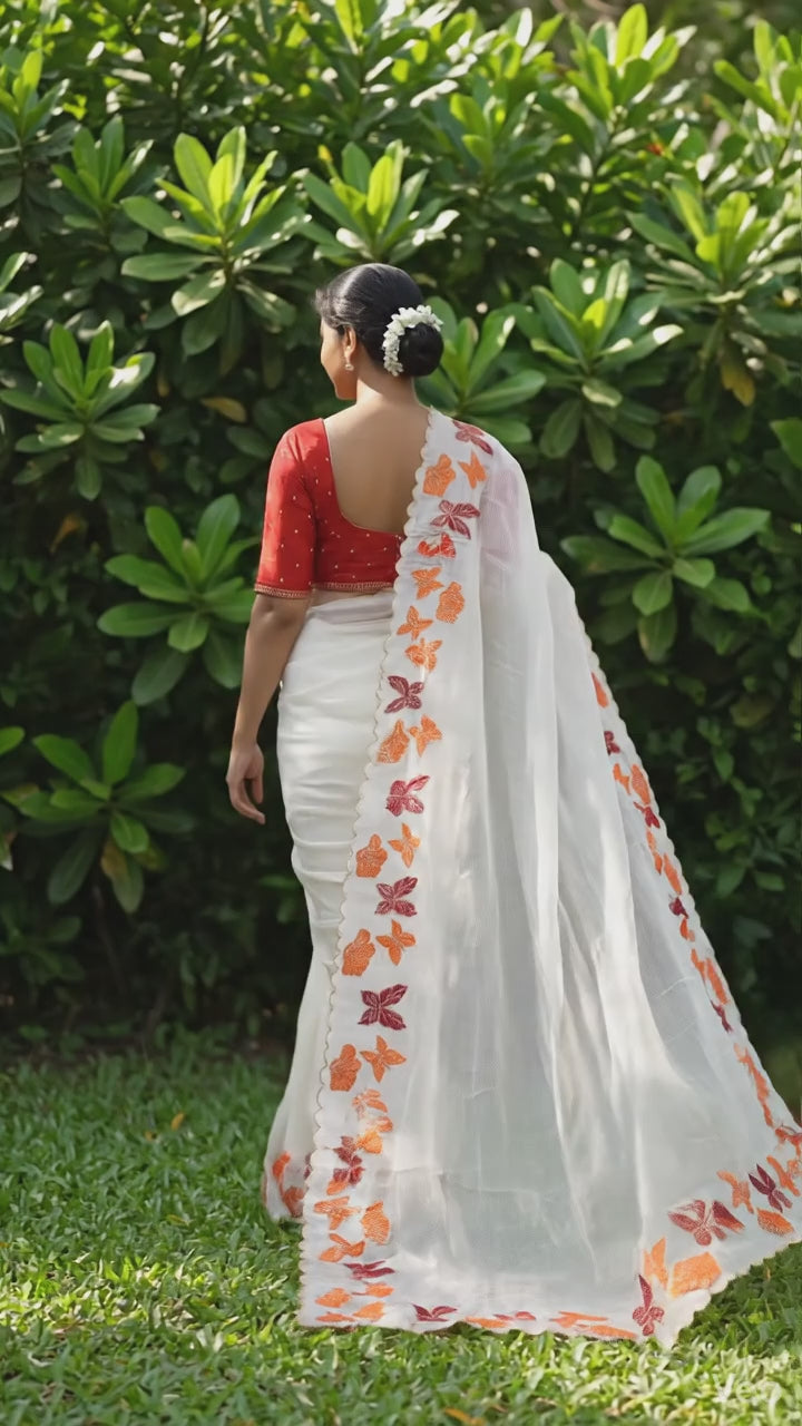 Elegant white chiffon saree featuring butterfly pattern and embroidered cutwork border